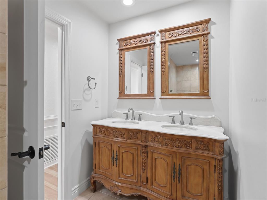 10916 Southeast Timucuan Road Summerfield, FL 34491 - Photo 26 of 40 a bathroom with a sink vanity and mirror