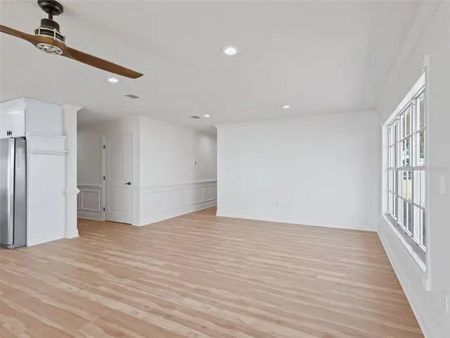 a large kitchen with stainless steel appliances granite countertop a large counter top and a wooden floors