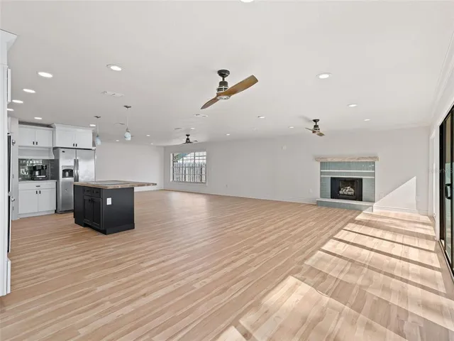 a view of kitchen with wooden floor and electronic appliances