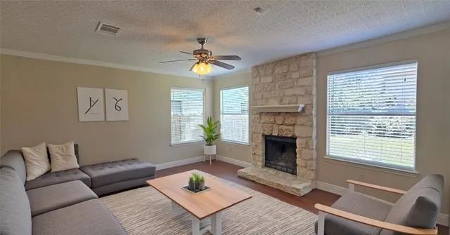 a living room with furniture and a fireplace