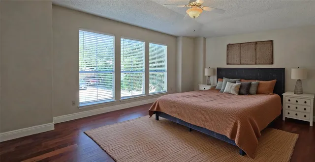 a bedroom with a large bed and a chandelier