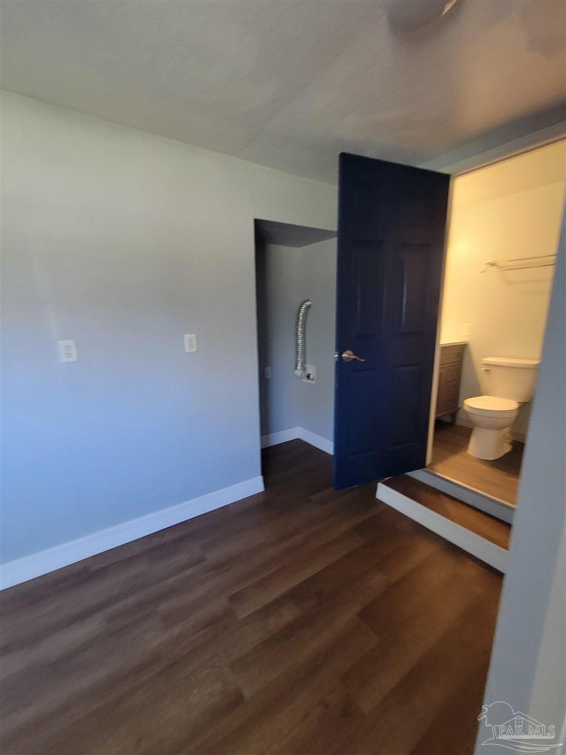 3217 Wallace Lake Road Pace, FL 32571 - Photo 12 of 17 a view of an empty room with wooden floor and a window