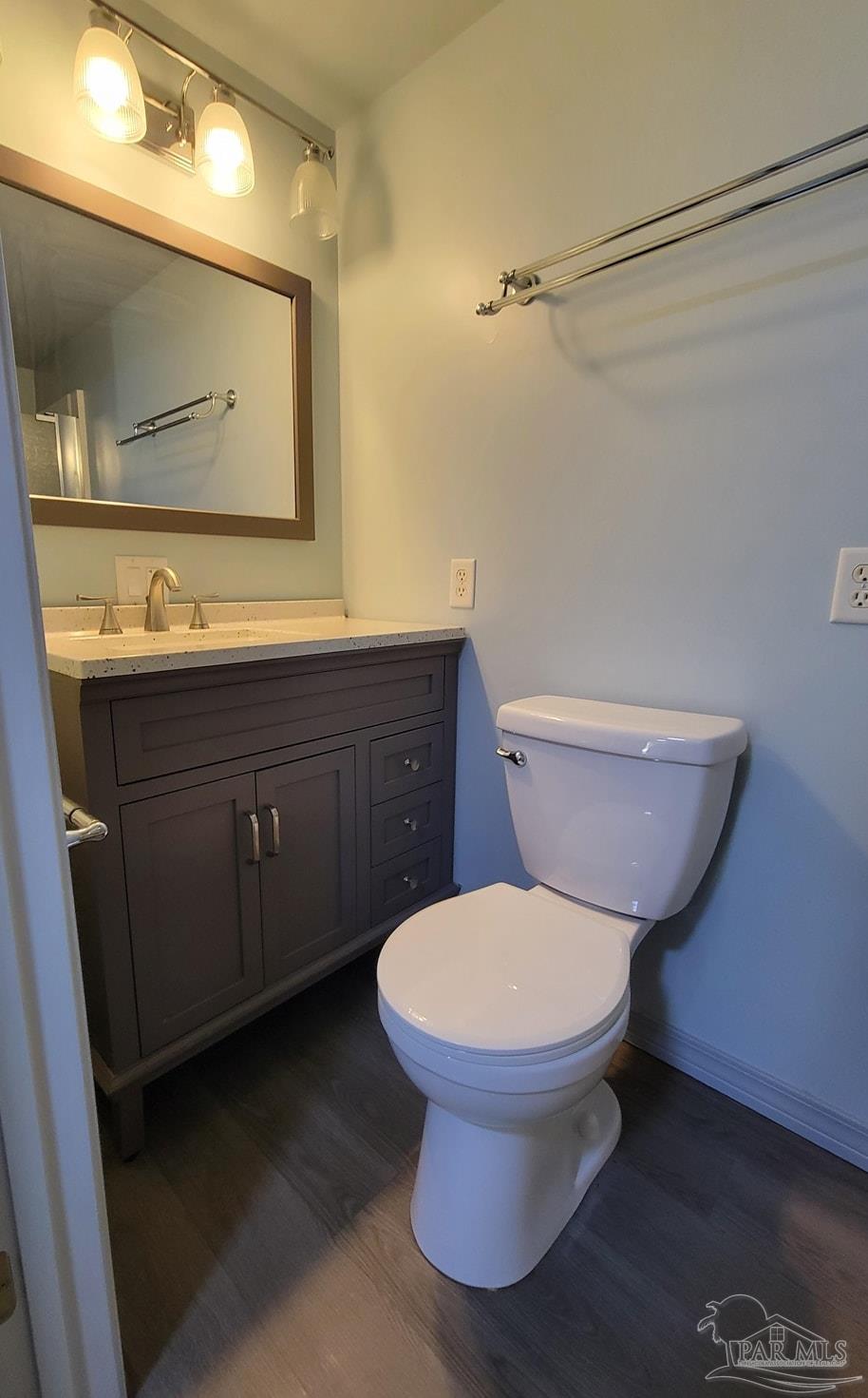 3217 Wallace Lake Road Pace, FL 32571 - Photo 14 of 17 a bathroom with a toilet sink and mirror