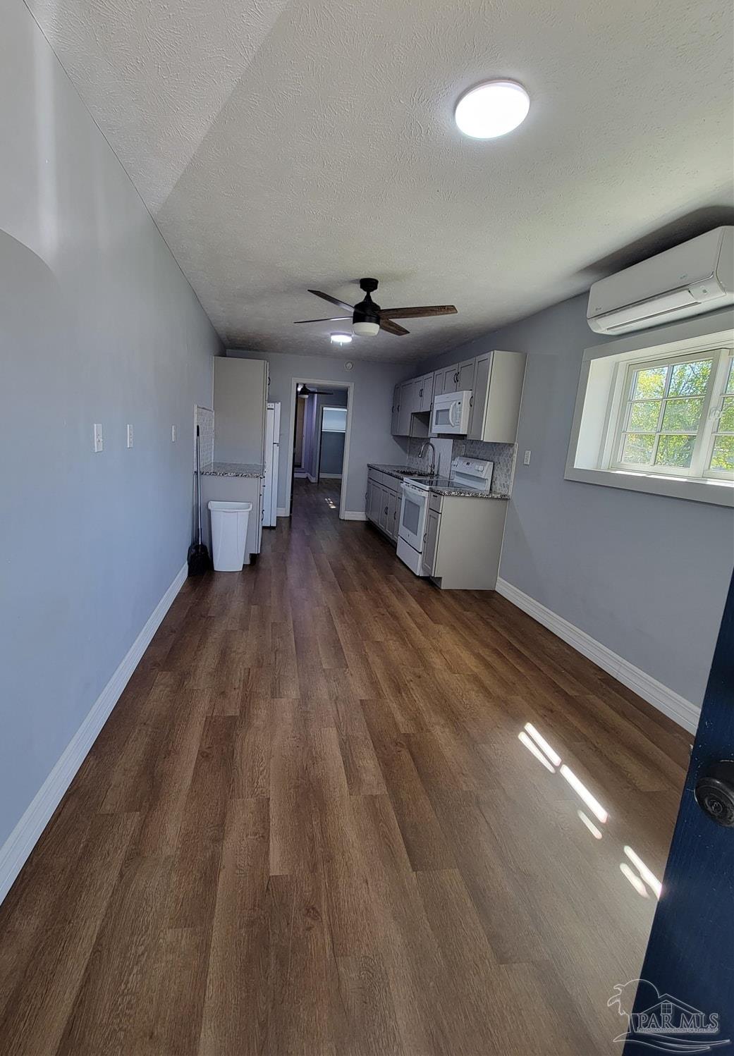 3217 Wallace Lake Road Pace, FL 32571 - Photo 7 of 17 a living room with furniture and a chandelier