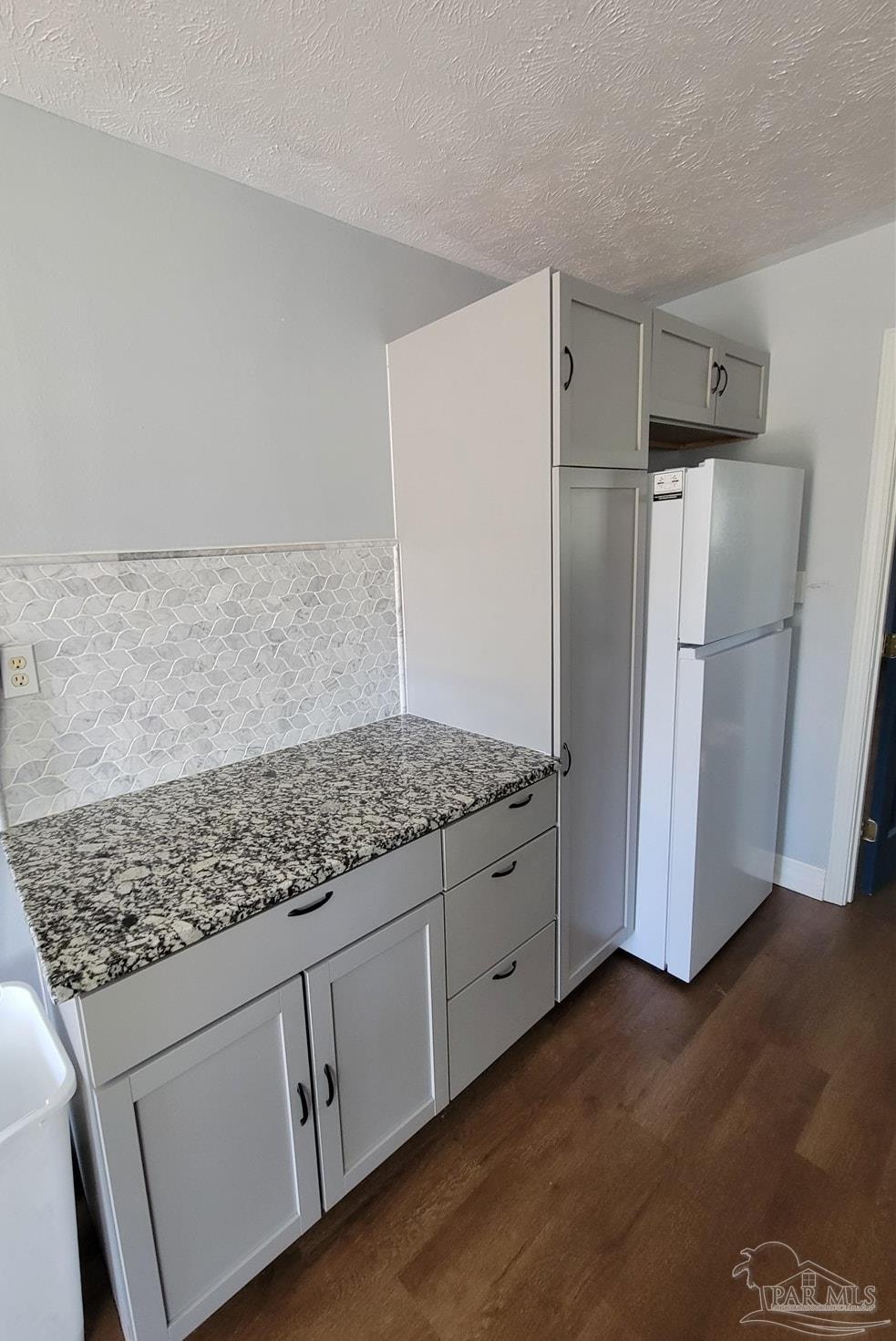 3217 Wallace Lake Road Pace, FL 32571 - Photo 9 of 17 a kitchen with stainless steel appliances granite countertop a refrigerator and a sink