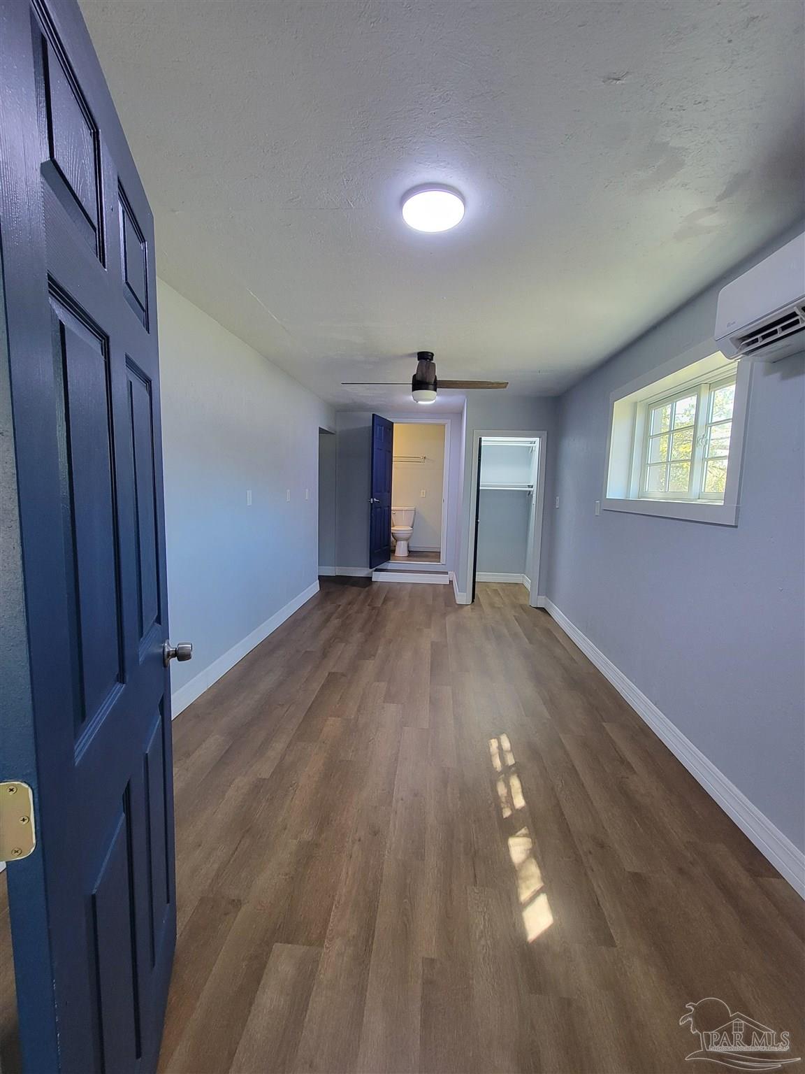 3217 Wallace Lake Road Pace, FL 32571 - Photo 10 of 17 wooden floor in an empty room with a window