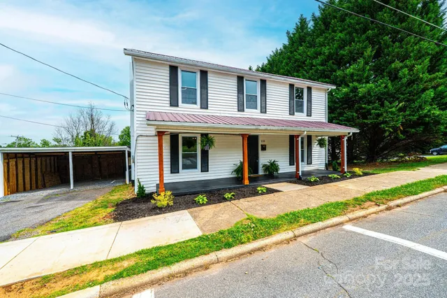 a front view of house with yard and outdoor seating