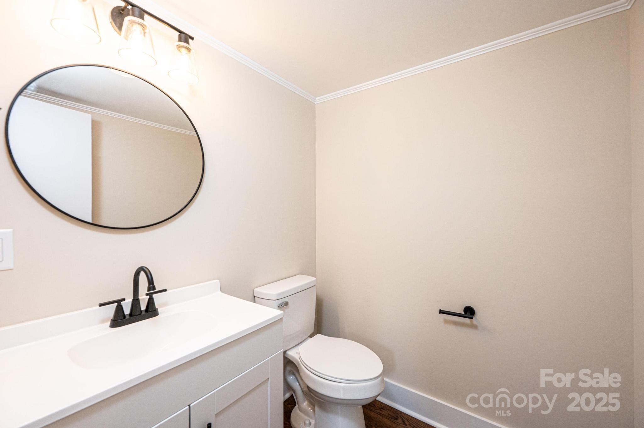210 West 15th Street Newton, NC 28658 - Photo 36 of 43 a bathroom with a sink a mirror and a toilet