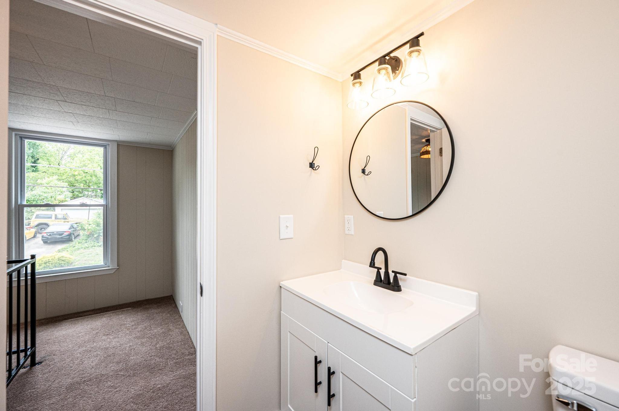 210 West 15th Street Newton, NC 28658 - Photo 37 of 43 a bathroom with a sink and a mirror