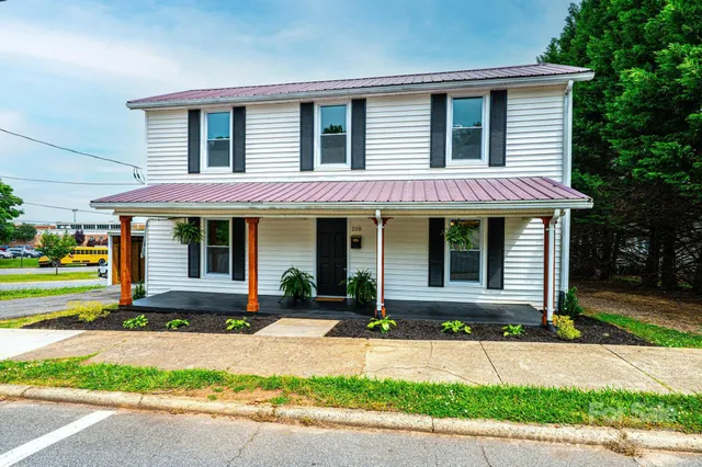 a front view of a house with a yard and porch