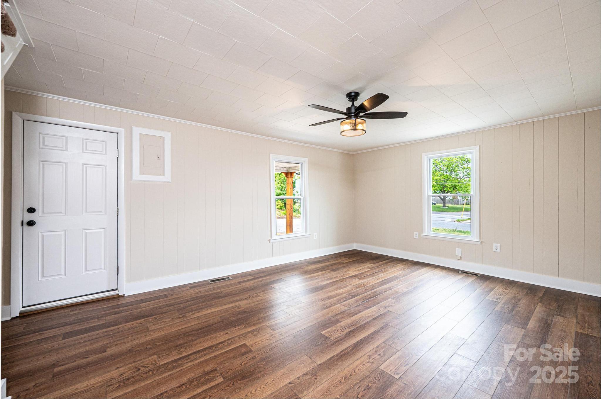 210 West 15th Street Newton, NC 28658 - Photo 10 of 43 an empty room with wooden floor and windows