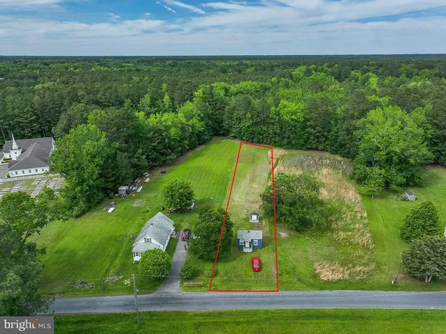 an aerial view of a residential houses with outdoor space and street view