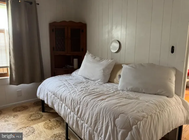 a bedroom with bed and window