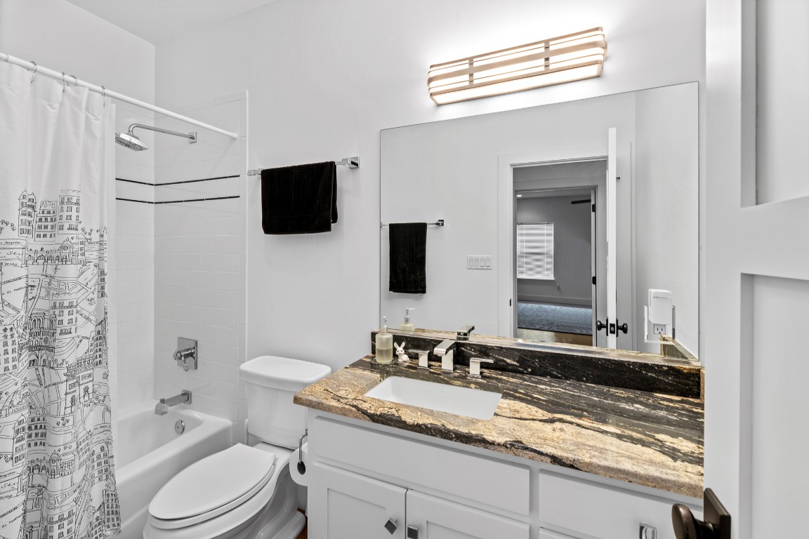 2321 Gentry Creek Road Menard, TX 76859 - Photo 23 of 35 a bathroom with a granite countertop sink toilet and shower