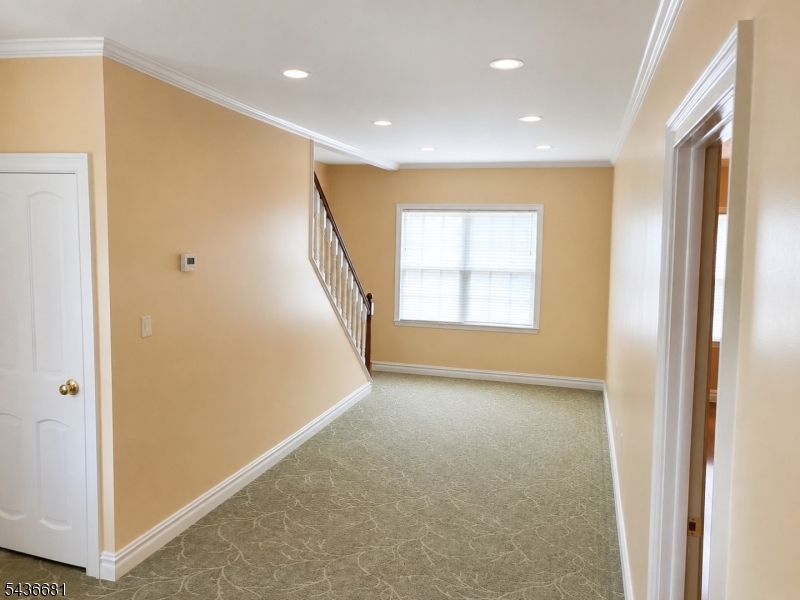178 East Lindsley Road, Unit 2 Cedar Grove, NJ 07009 - Photo 12 of 28 a view of hallway with window and stairs