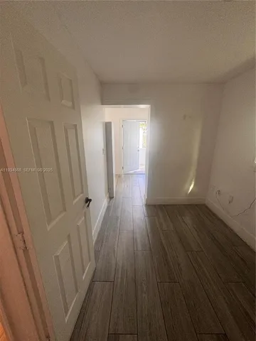 a view of a room with wooden floor