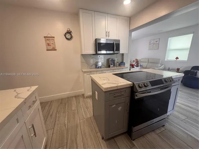 a kitchen with a sink stove and microwave