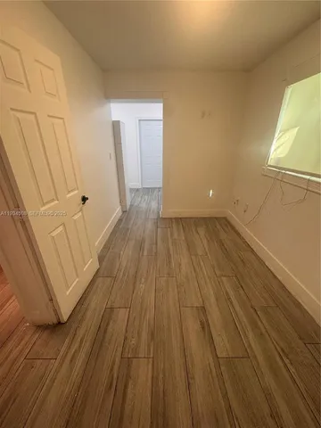 a view of a room with wooden floor and staircase