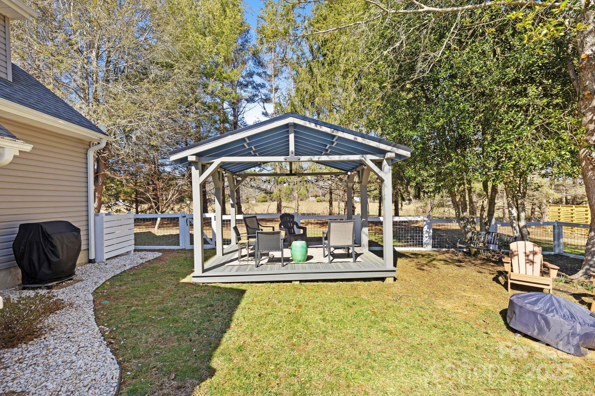 321 Ballenger Road Flat Rock, NC 28731 - Photo 25 of 32 a view of a patio with a table chairs and a fire pit