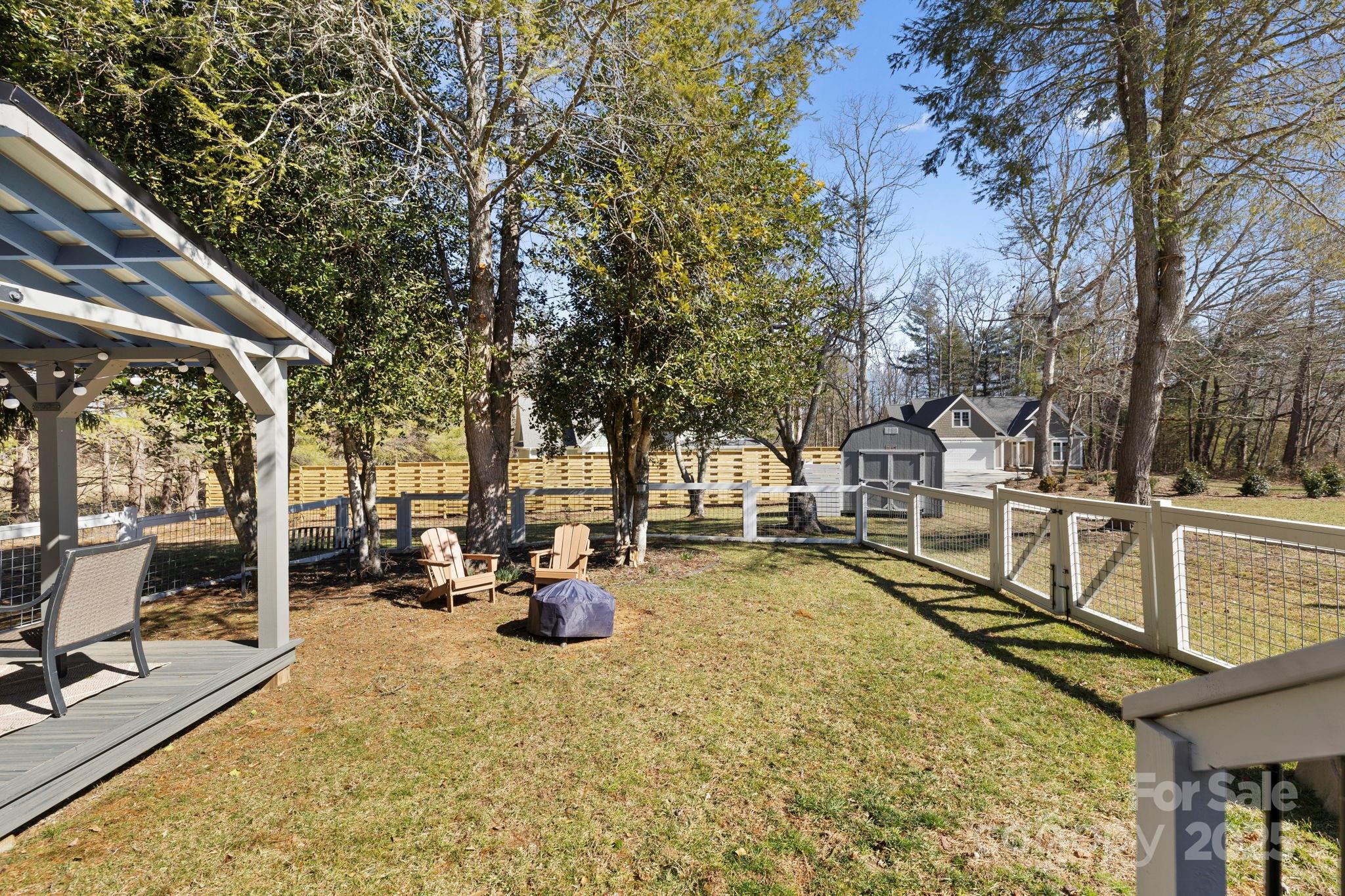 321 Ballenger Road Flat Rock, NC 28731 - Photo 26 of 32 a view of a swimming pool with a patio and a garden
