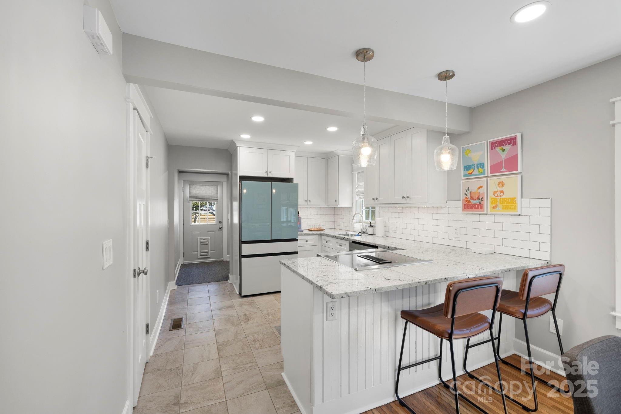 321 Ballenger Road Flat Rock, NC 28731 - Photo 5 of 32 a kitchen with stainless steel appliances kitchen island granite countertop a sink and cabinets