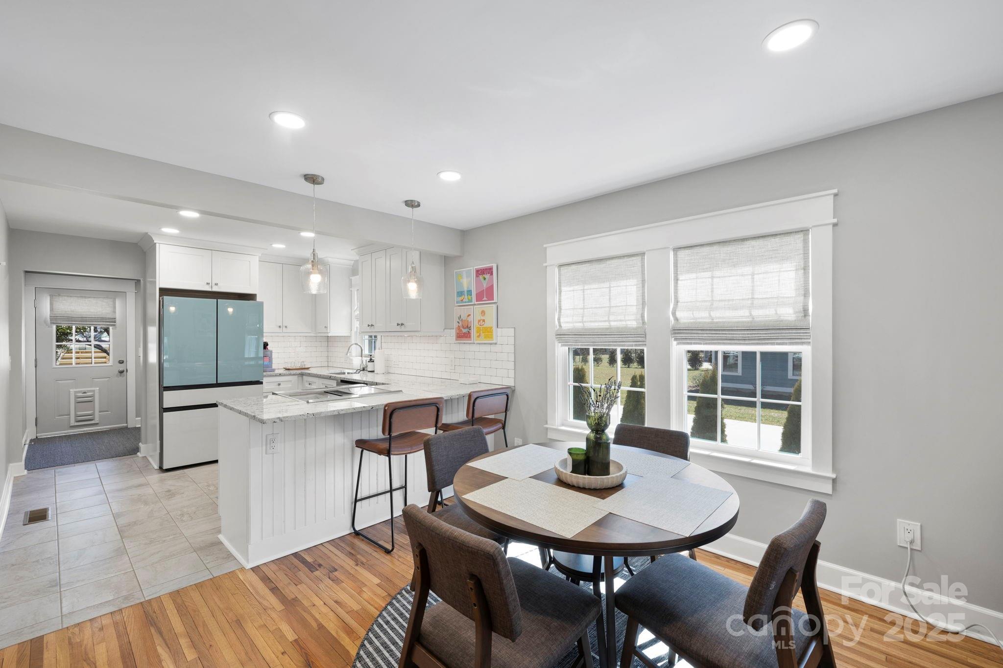 321 Ballenger Road Flat Rock, NC 28731 - Photo 8 of 32 a view of a dining room with furniture and wooden floor