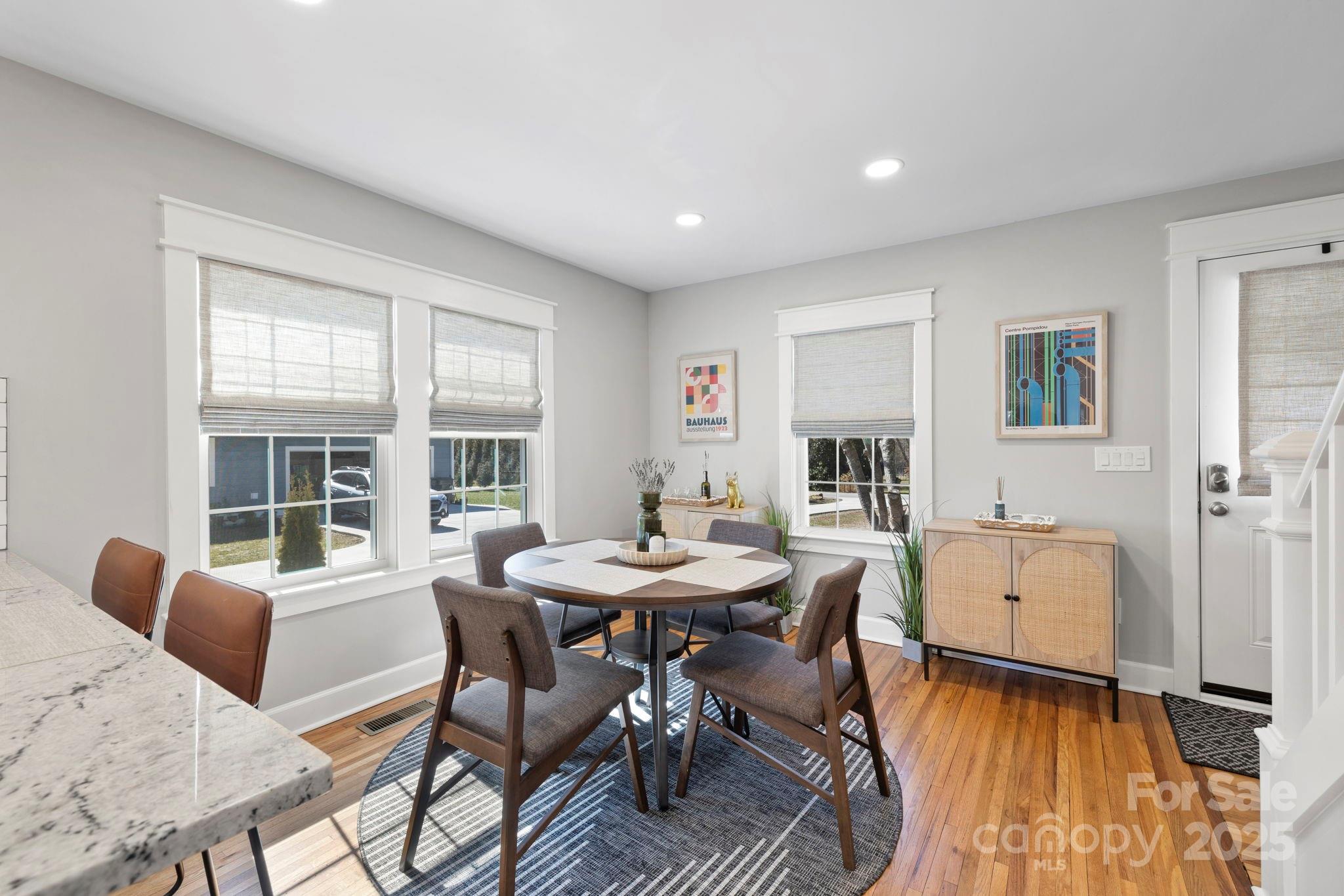 321 Ballenger Road Flat Rock, NC 28731 - Photo 9 of 32 a view of a dining room with furniture window and wooden floor