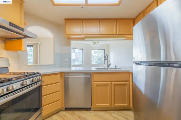 a view of storage and utility room with wooden floor and window