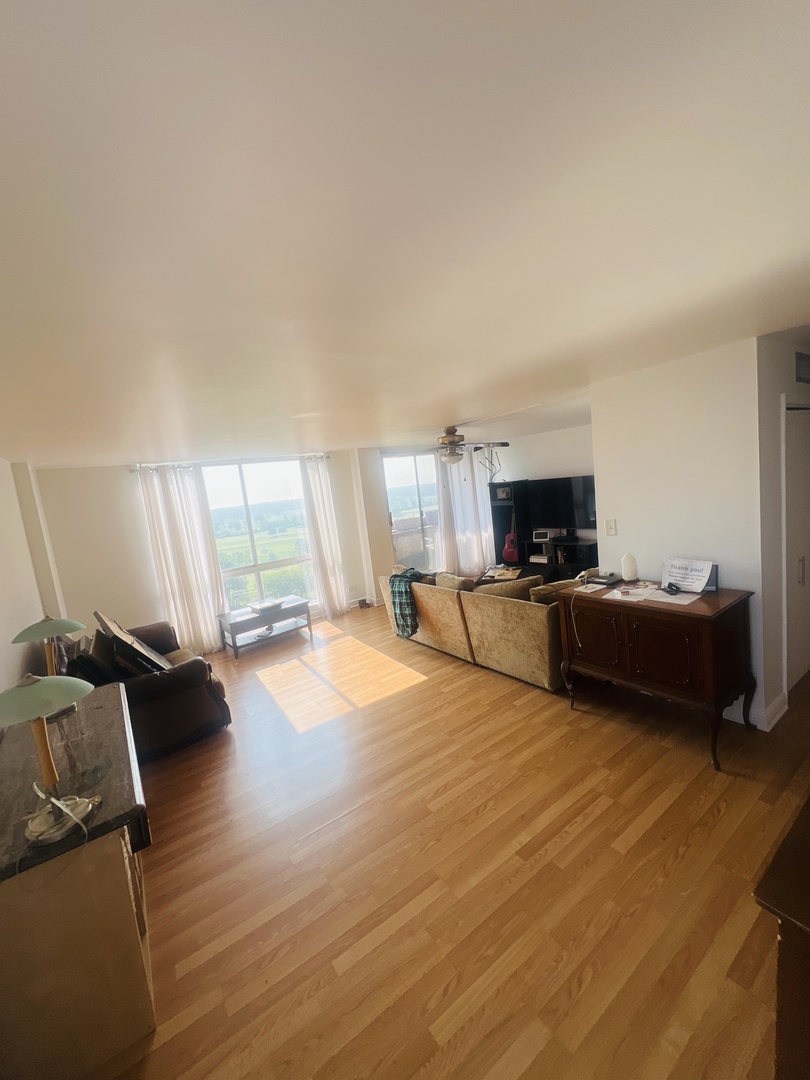 465 West Dominion Drive, Unit 1302 Wood Dale, IL 60191 - Photo 11 of 19 a living room with furniture and a flat screen tv