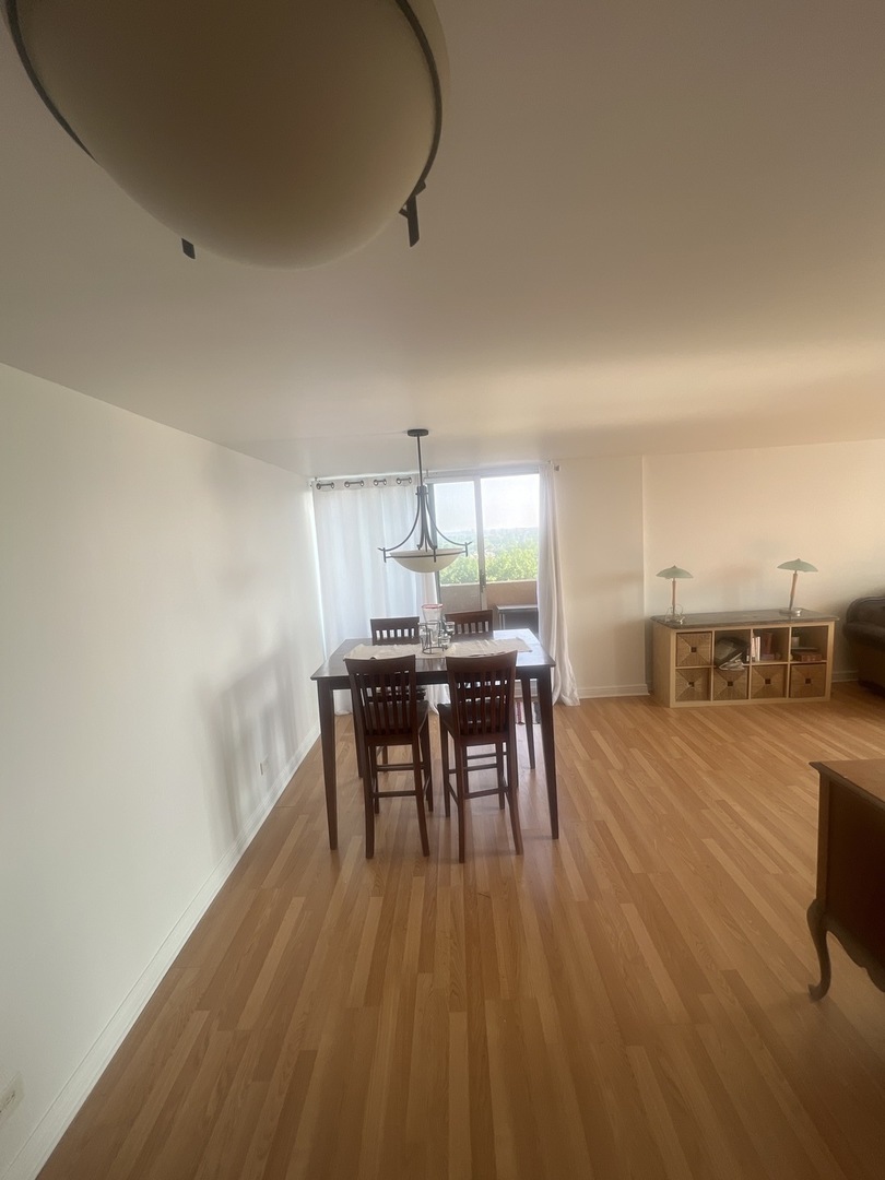 465 West Dominion Drive, Unit 1302 Wood Dale, IL 60191 - Photo 12 of 19 a dining room with furniture and wooden floor