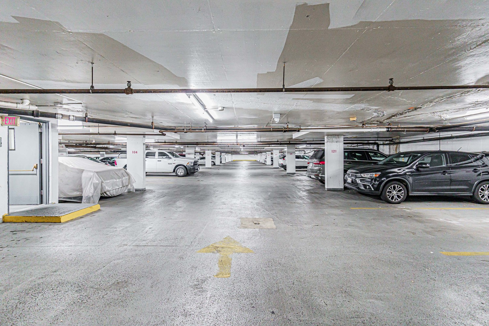 465 West Dominion Drive, Unit 1302 Wood Dale, IL 60191 - Photo 17 of 19 a view of parking garage with cars