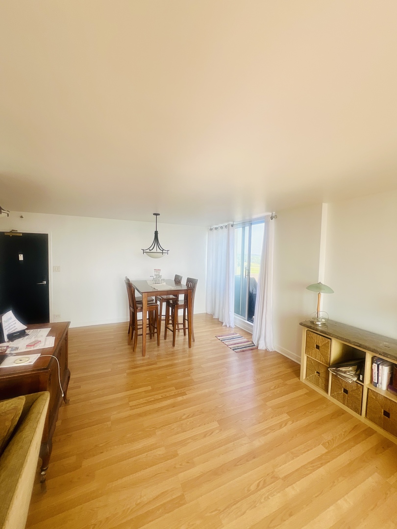 465 West Dominion Drive, Unit 1302 Wood Dale, IL 60191 - Photo 5 of 19 a living room with furniture and a table