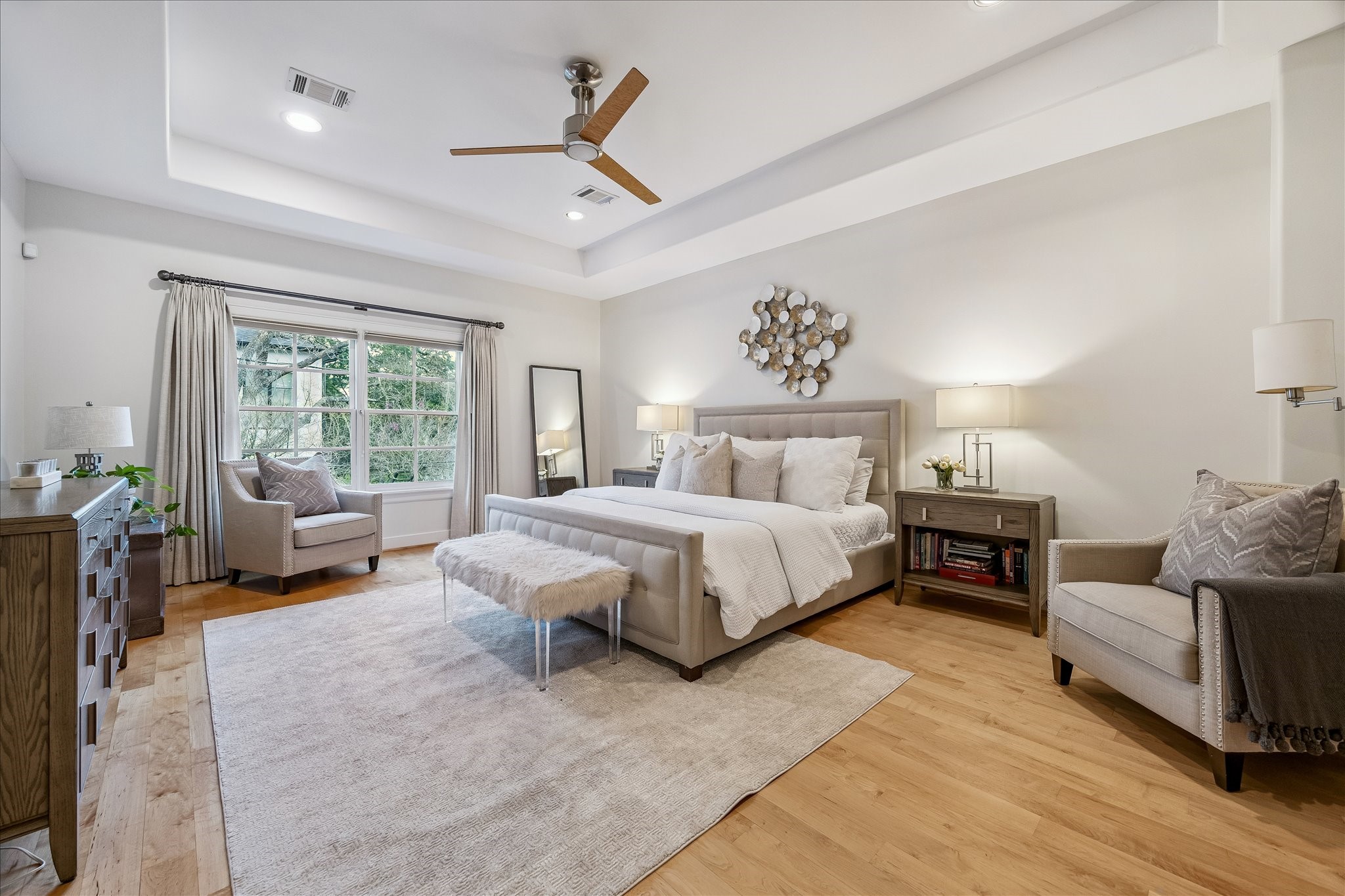 4010 Milton Street Houston, TX 77005 - Photo 20 of 49 PRIMARY BEDROOM. The expansive primary suite offers a quiet escape with its back of the home location and calming color palette. Note the hardwood flooring continues throughout the 2nd floor bedrooms.