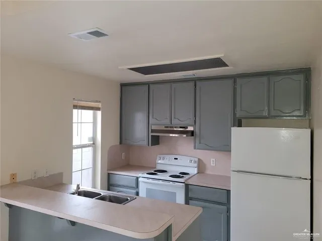 a kitchen with a sink a stove and refrigerator