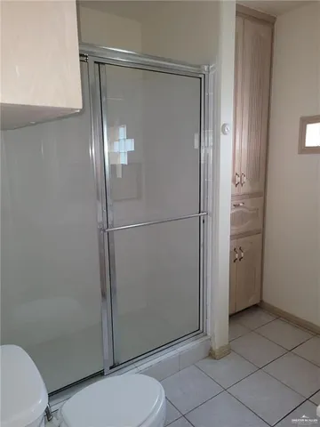 a bathroom with a glass shower door