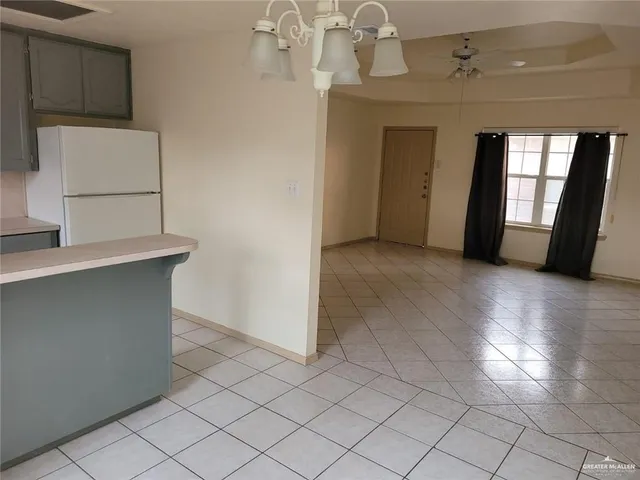 an empty room with windows and cabinet
