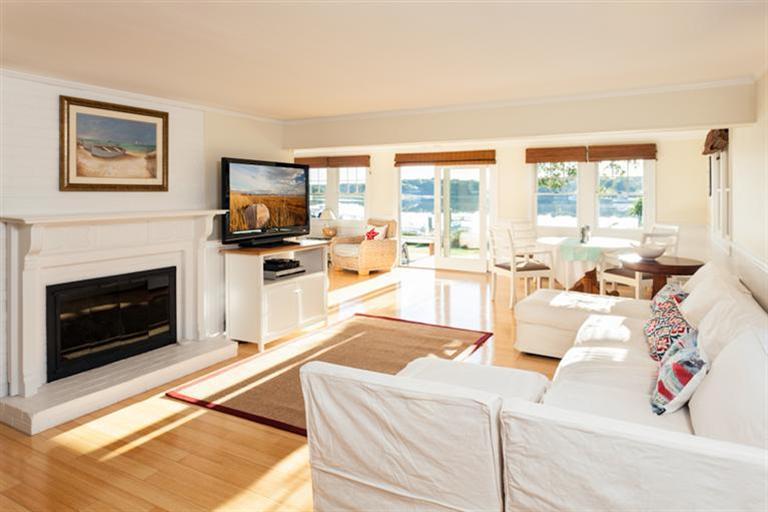 2 Great River Road Mashpee, MA 02649 - Photo 2 of 16 a living room with furniture a flat screen tv and a fireplace