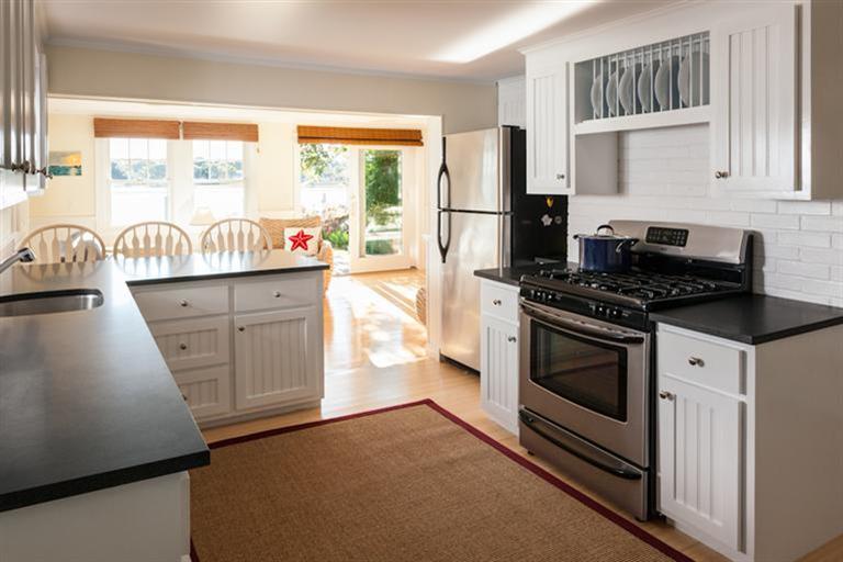 2 Great River Road Mashpee, MA 02649 - Photo 9 of 16 a kitchen with granite countertop a stove a sink and a refrigerator