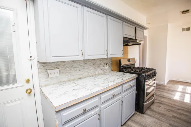 a kitchen with granite countertop cabinets washer and dryer