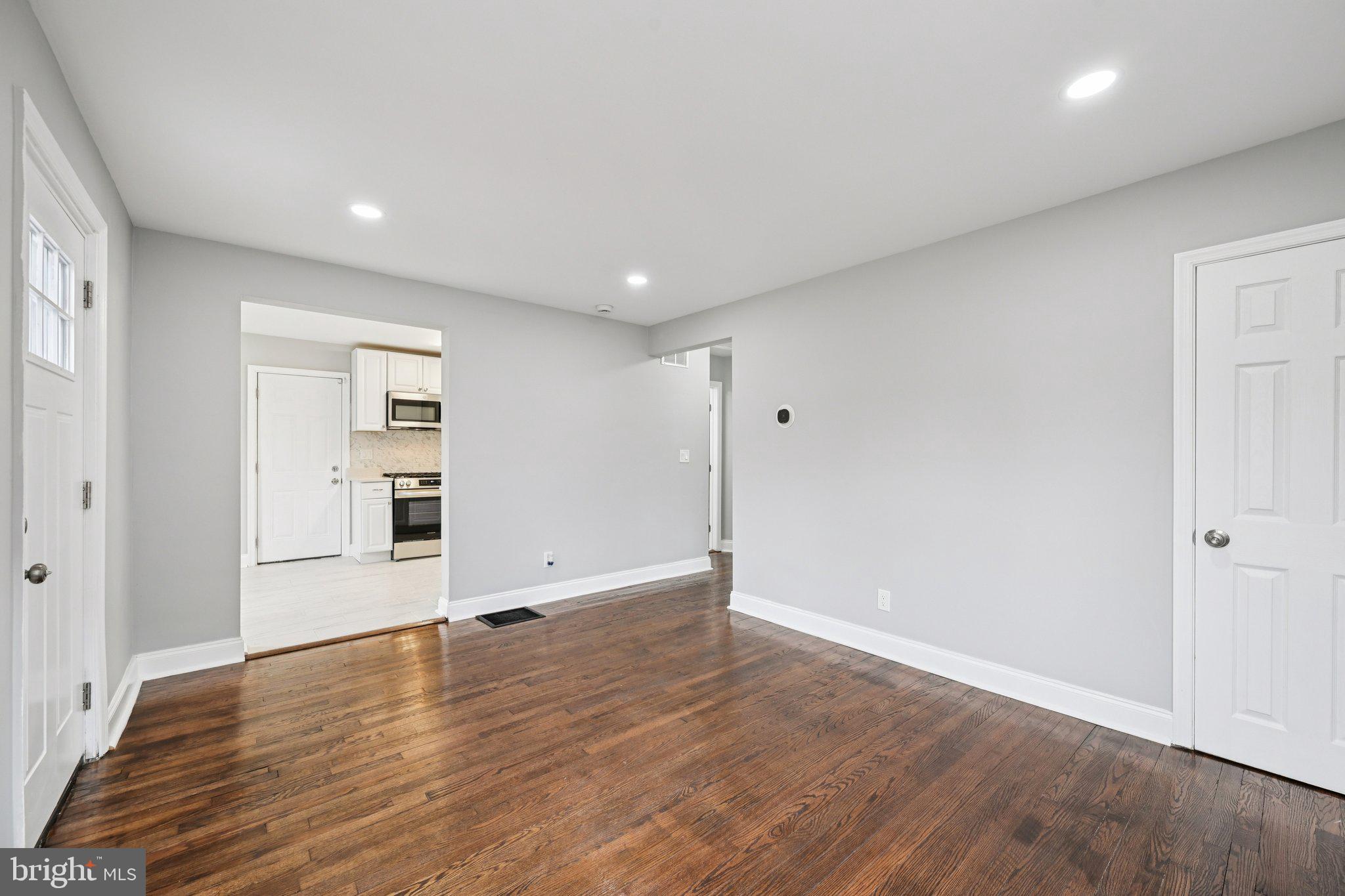 4902 Gilray Drive Baltimore, MD 21214 - Photo 12 of 54 a view of an empty room with wooden floor