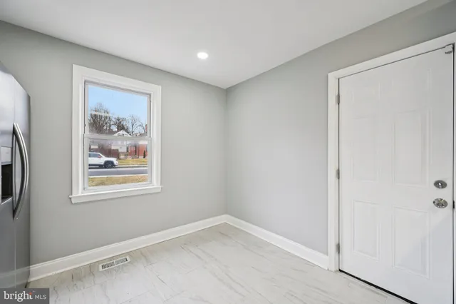 an empty room with windows and closet