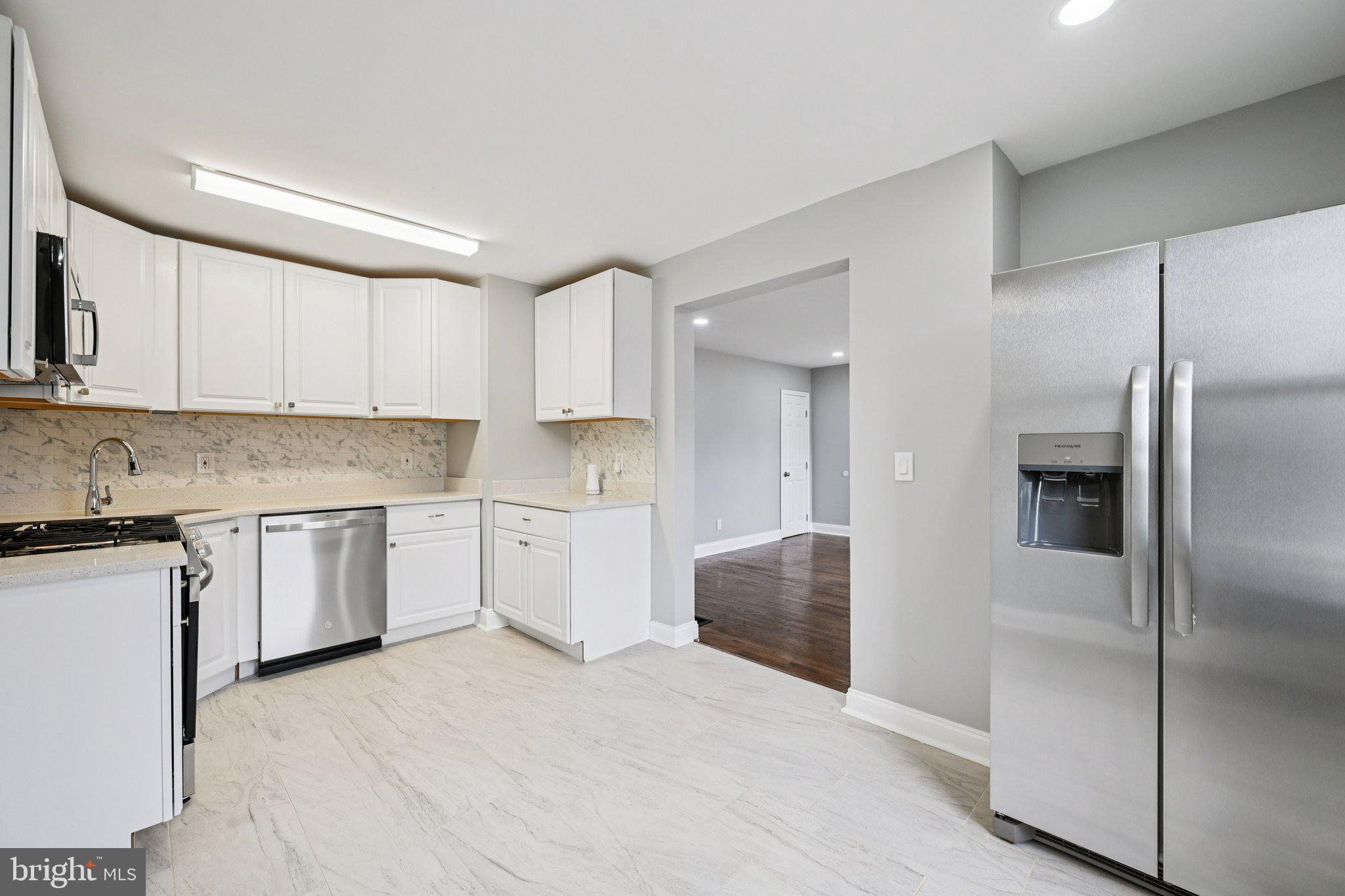 4902 Gilray Drive Baltimore, MD 21214 - Photo 17 of 54 a kitchen with a refrigerator sink and cabinets