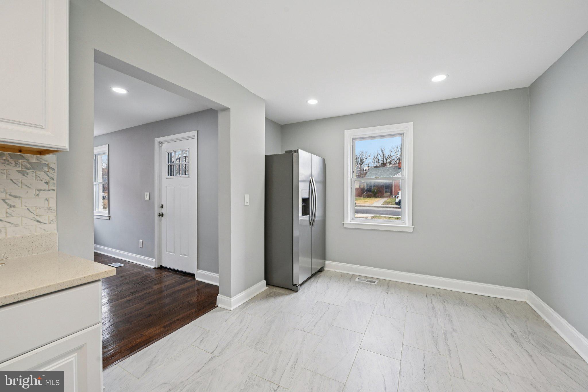4902 Gilray Drive Baltimore, MD 21214 - Photo 20 of 54 a view of an empty room with window and wooden floor