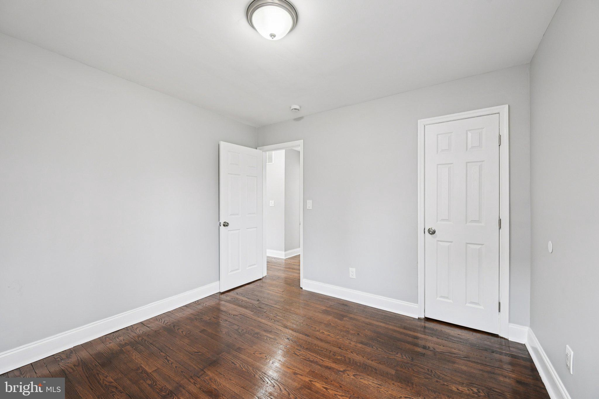 4902 Gilray Drive Baltimore, MD 21214 - Photo 24 of 54 a view of an empty room with wooden floor