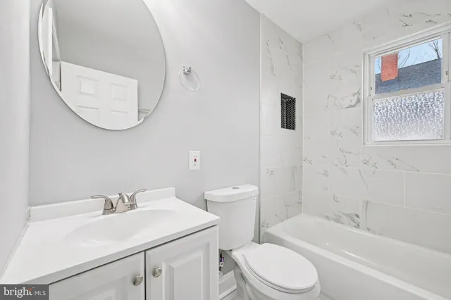 a bathroom with a sink toilet and a bathtub