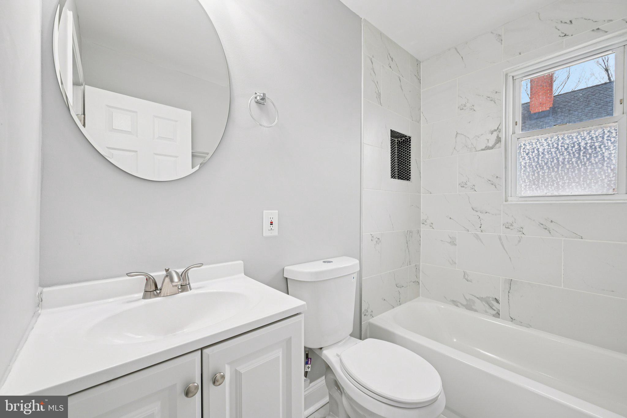 4902 Gilray Drive Baltimore, MD 21214 - Photo 28 of 54 a bathroom with a sink toilet and a bathtub