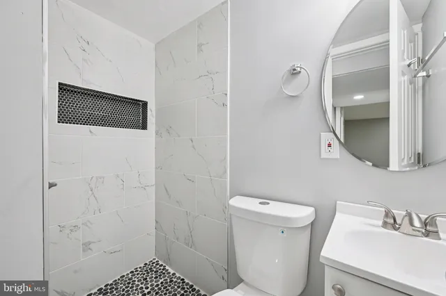 a bathroom with a sink and mirror with window