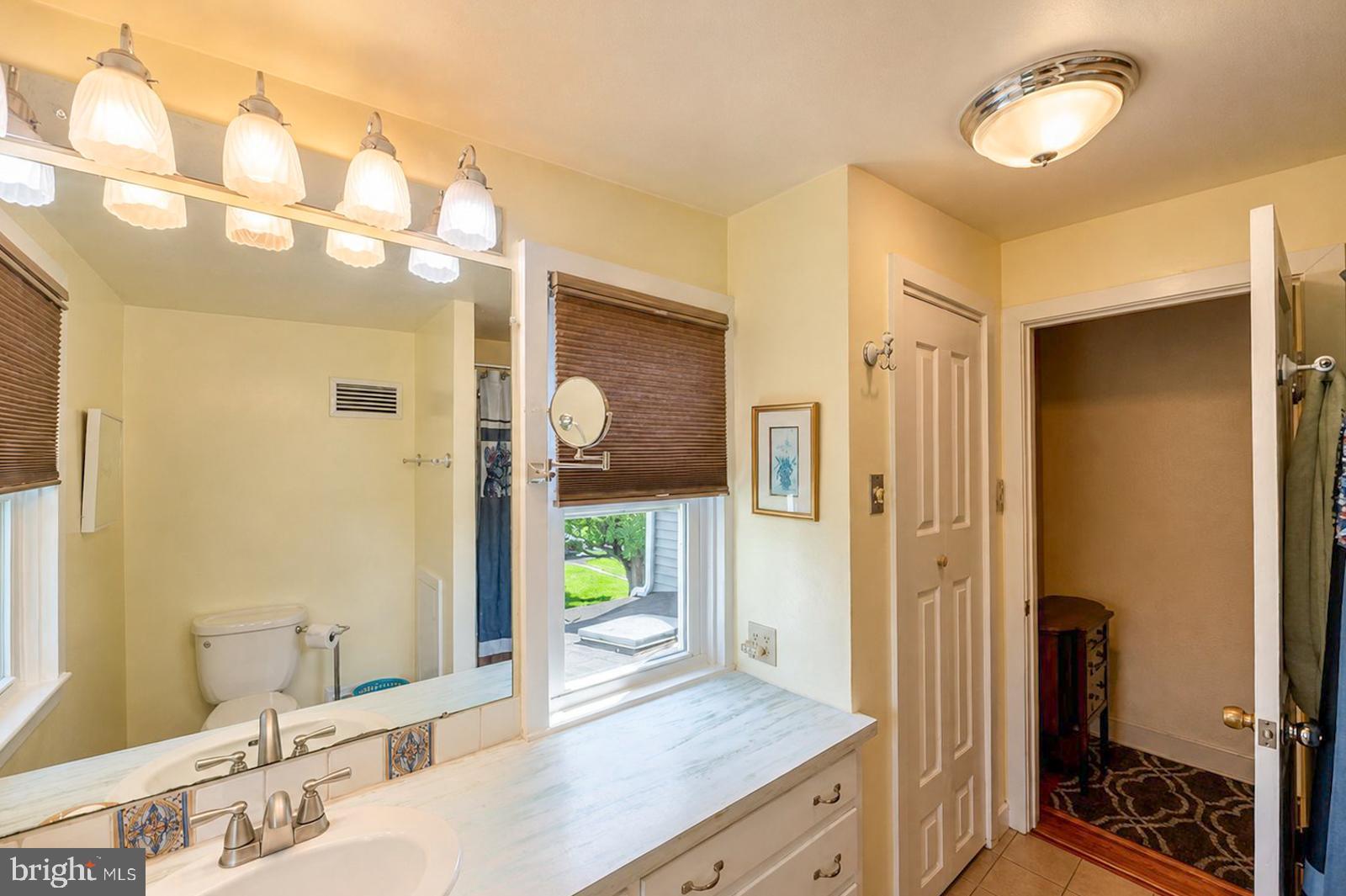 222 Blue School Road Perkasie, PA 18944 - Photo 48 of 77 a bathroom with a granite countertop sink a mirror and a shower