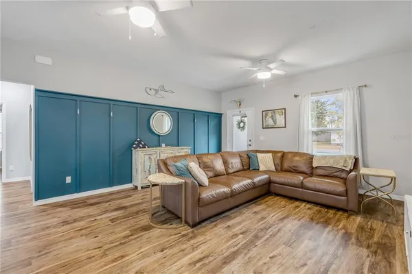 a kitchen with stainless steel appliances a dining table chairs and white cabinets
