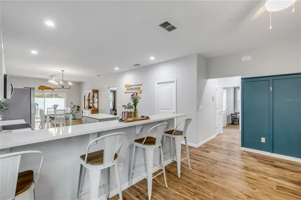 a kitchen with cabinets and wooden floor